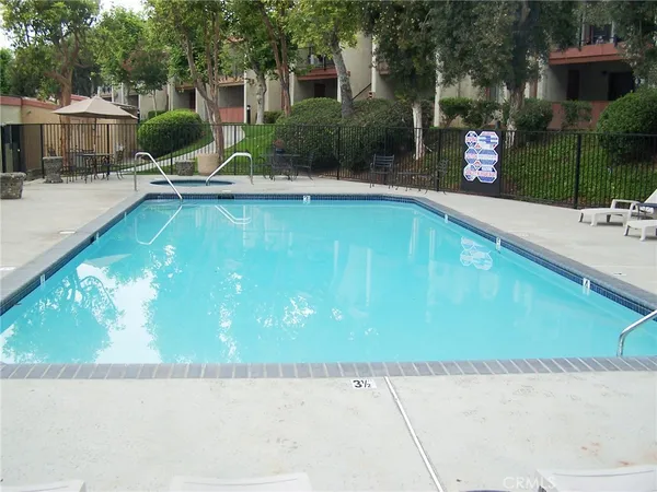 swimming pool view with a seating space