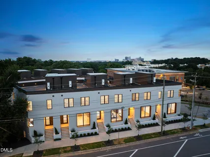 a front view of a residential apartment building with a yard