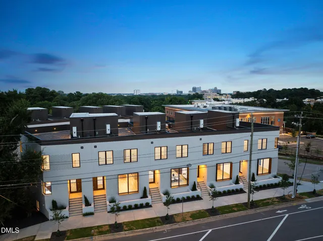 a front view of a residential apartment building with a yard