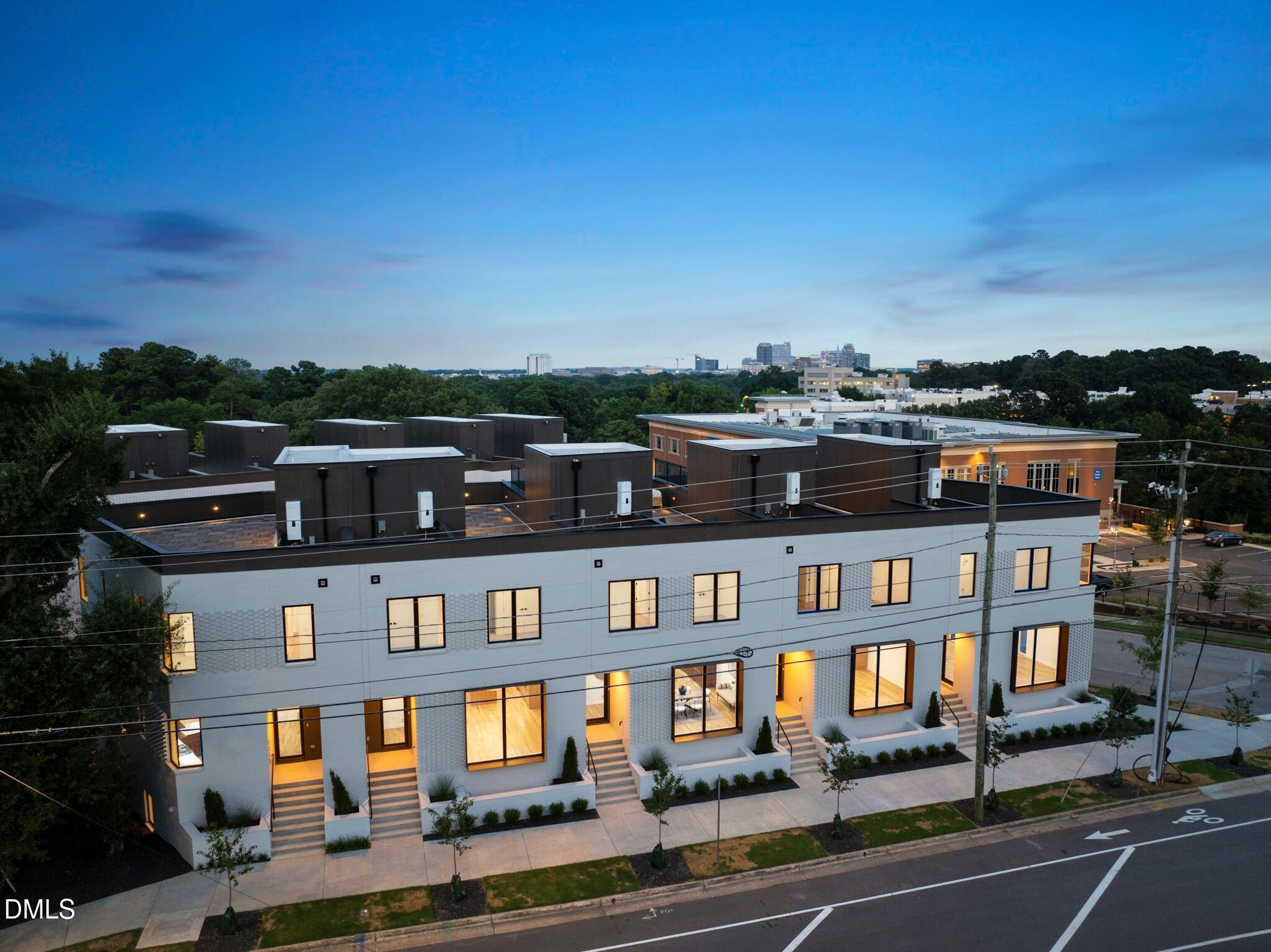 a front view of a residential apartment building with a yard