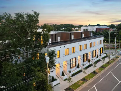 a view of a white building among the street
