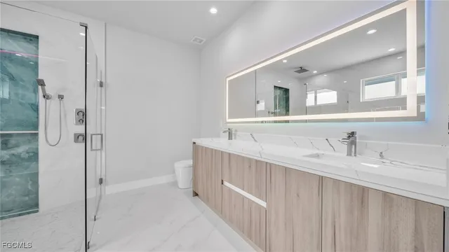 a bathroom with a granite countertop sink mirror and double