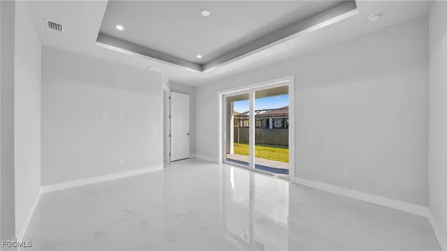 an empty room with an empty room and glass door