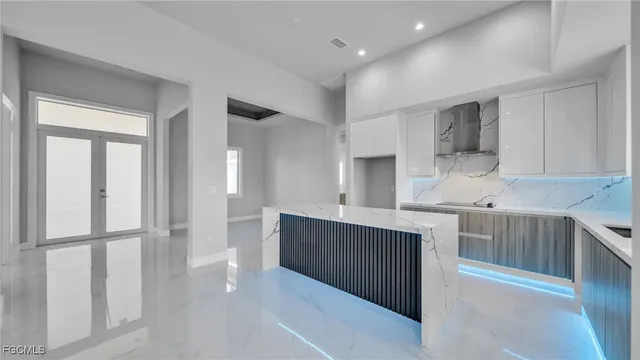 a kitchen with stainless steel appliances a sink stove and cabinets
