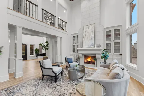a living room with furniture kitchen view and a chandelier