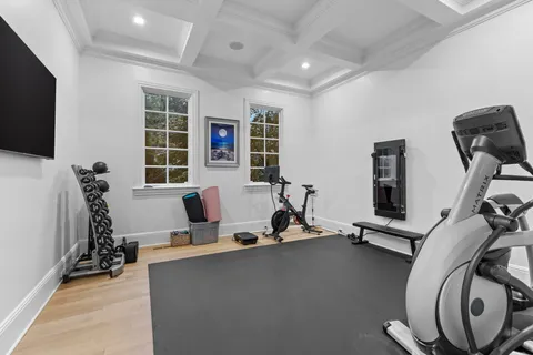 a spacious bedroom with a bed a couch and a chandelier