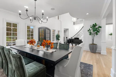 a living room with furniture a fireplace and potted plants