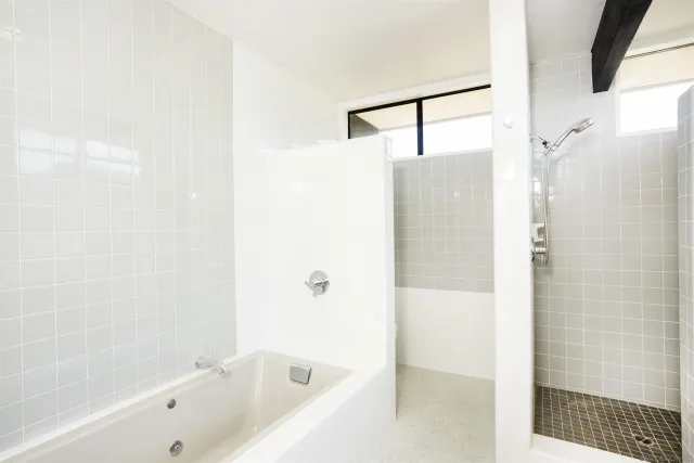 a bathroom with a bathtub and shower