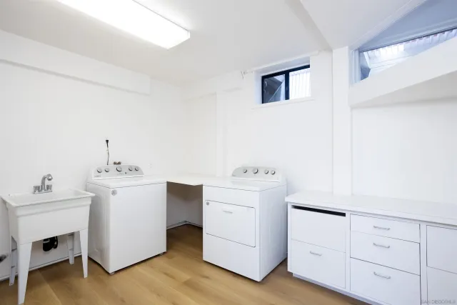 a utility room with cabinets washer and dryer