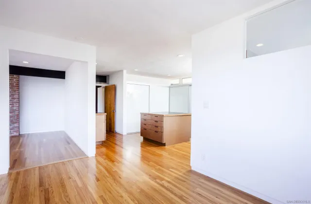 a view of a living room with wooden floor