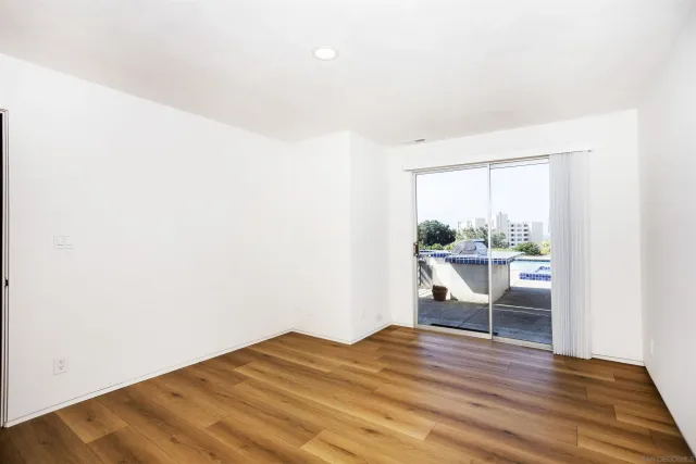 a workspace with wooden floor and a window