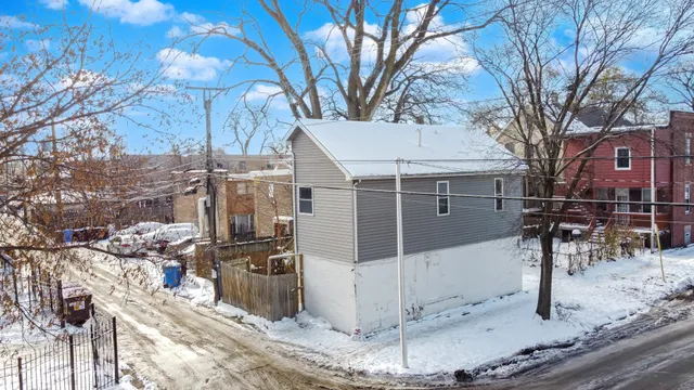 a view of a house with a wooden fence