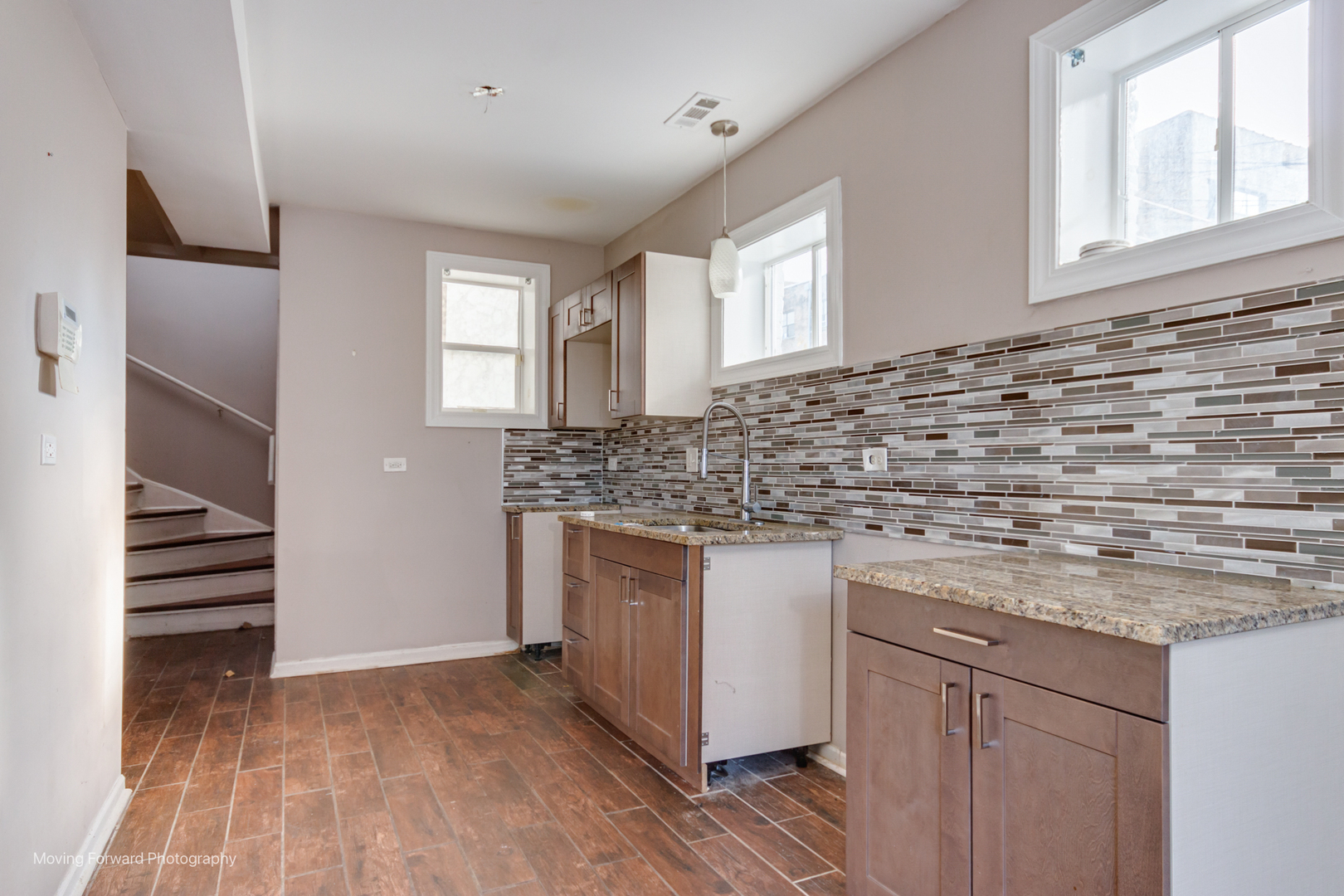1715 East 70th Street Chicago, IL 60649 - Photo 16 of 29 a kitchen with stainless steel appliances granite countertop a sink and cabinets