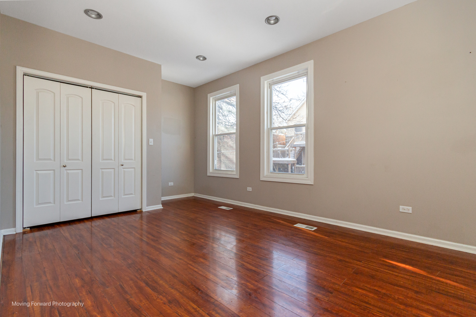 1715 East 70th Street Chicago, IL 60649 - Photo 22 of 29 an empty room with wooden floor and windows