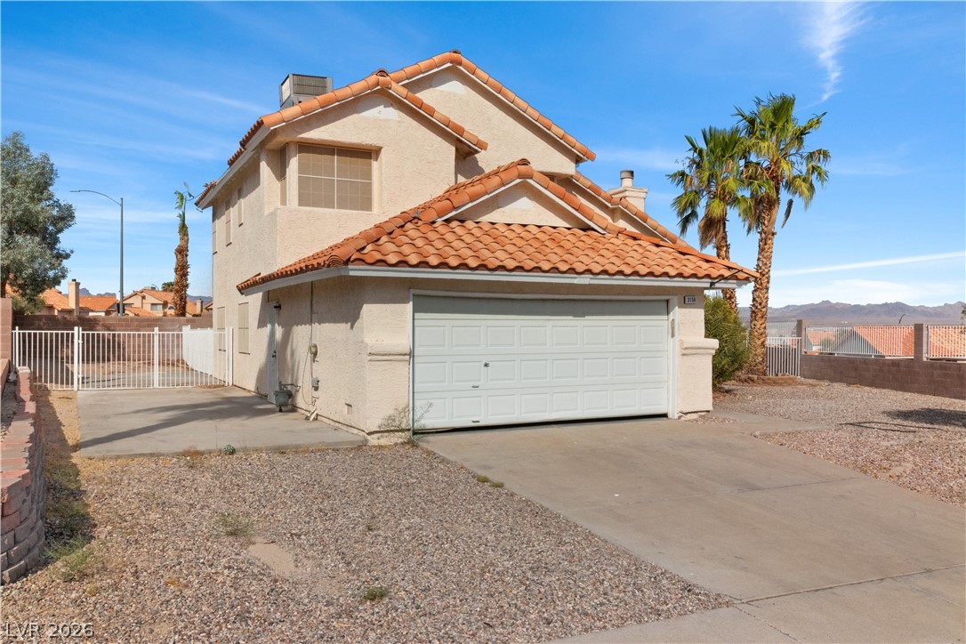 3156 Terrace View Drive Laughlin, NV 89029 - Photo 54 of 94 A classic two-story residence with a tan stucco facade and traditional clay tile roofing.