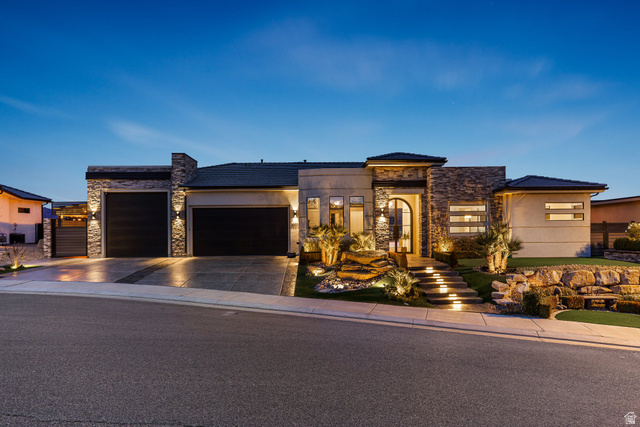3022 West Sesia Way St. George, UT 84770 - Photo 42 of 52 View of front of house featuring stone siding, a garage, driveway, and stucco siding