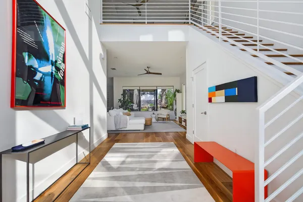 a living room with furniture tv and a large window