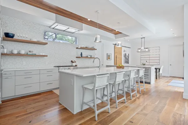 a kitchen with cabinets and chairs