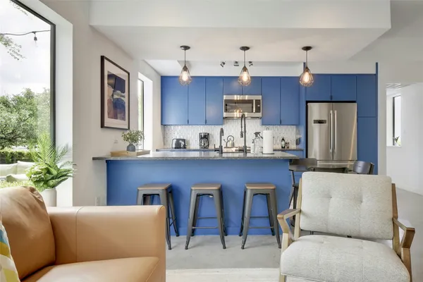 a living room with stainless steel appliances kitchen island granite countertop furniture and a kitchen view