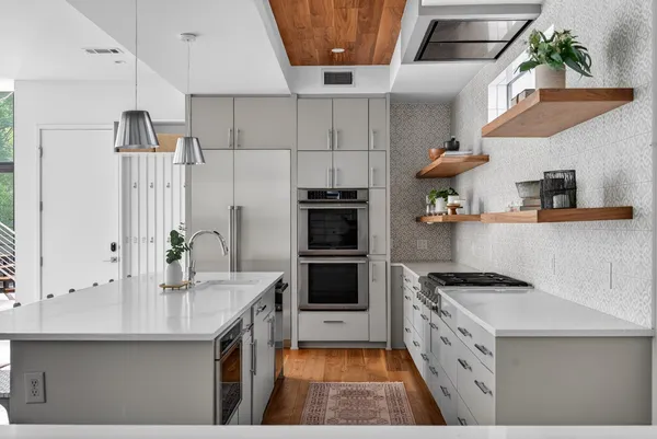 a kitchen with stainless steel appliances granite countertop a stove and a refrigerator