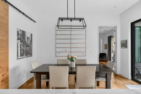 a living room with furniture and large windows