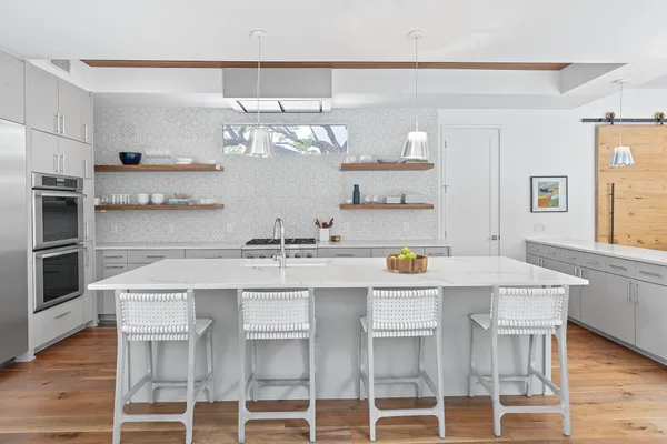 a kitchen with stainless steel appliances granite countertop a sink and stove