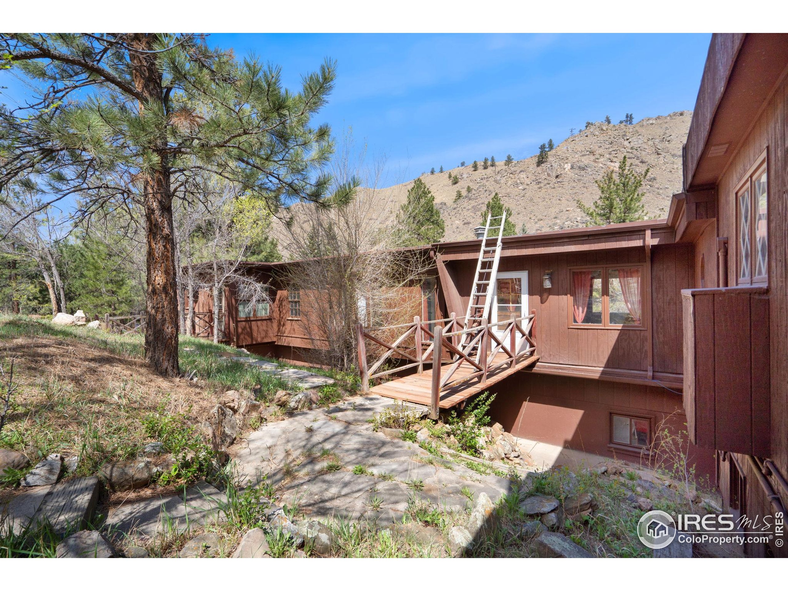 7301 Poudre Canyon Road Bellvue, CO 80512 - Photo 24 of 41 a backyard of a house with barbeque oven