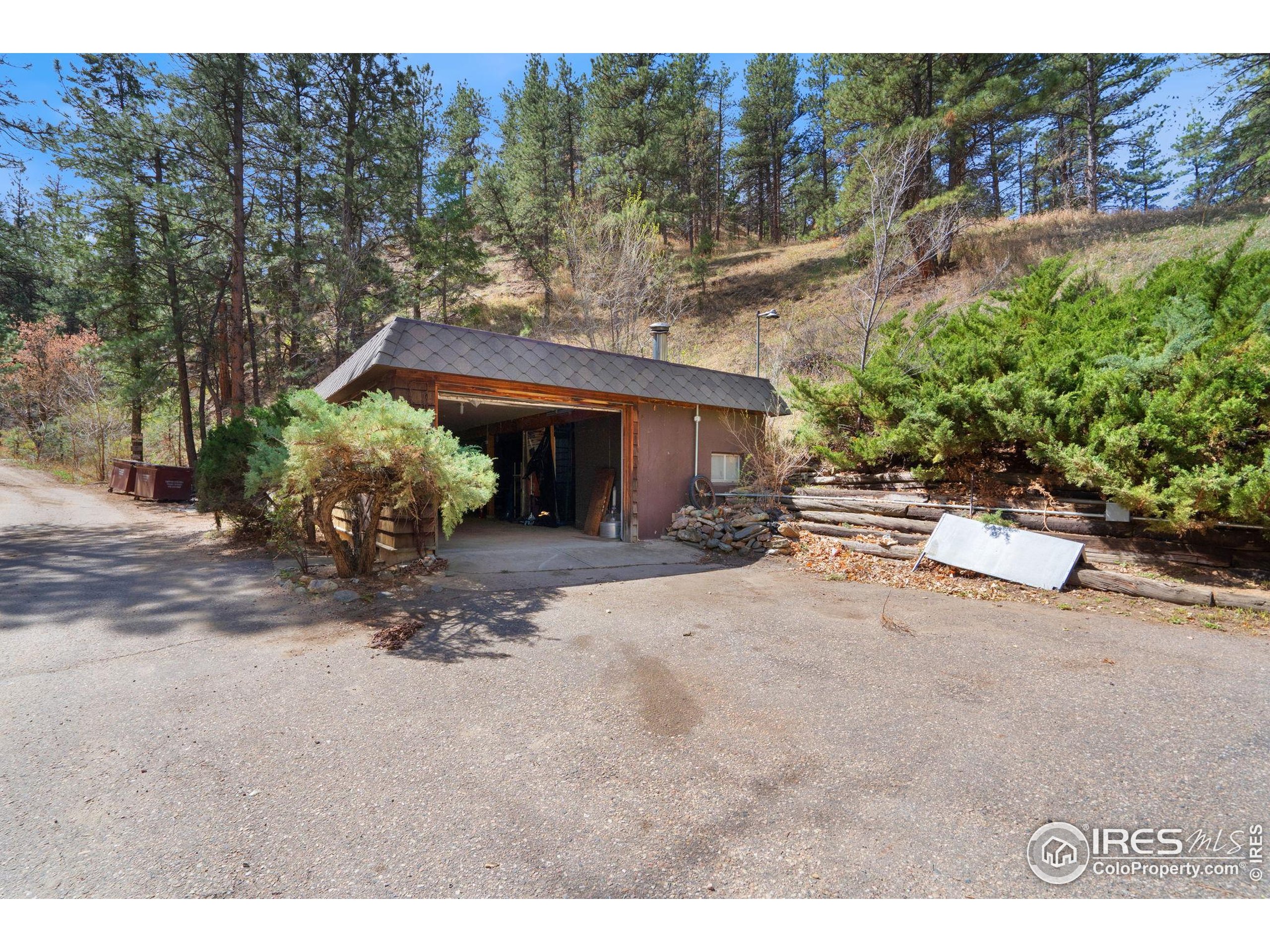 7301 Poudre Canyon Road Bellvue, CO 80512 - Photo 29 of 41 a view of a house with a yard and sitting area