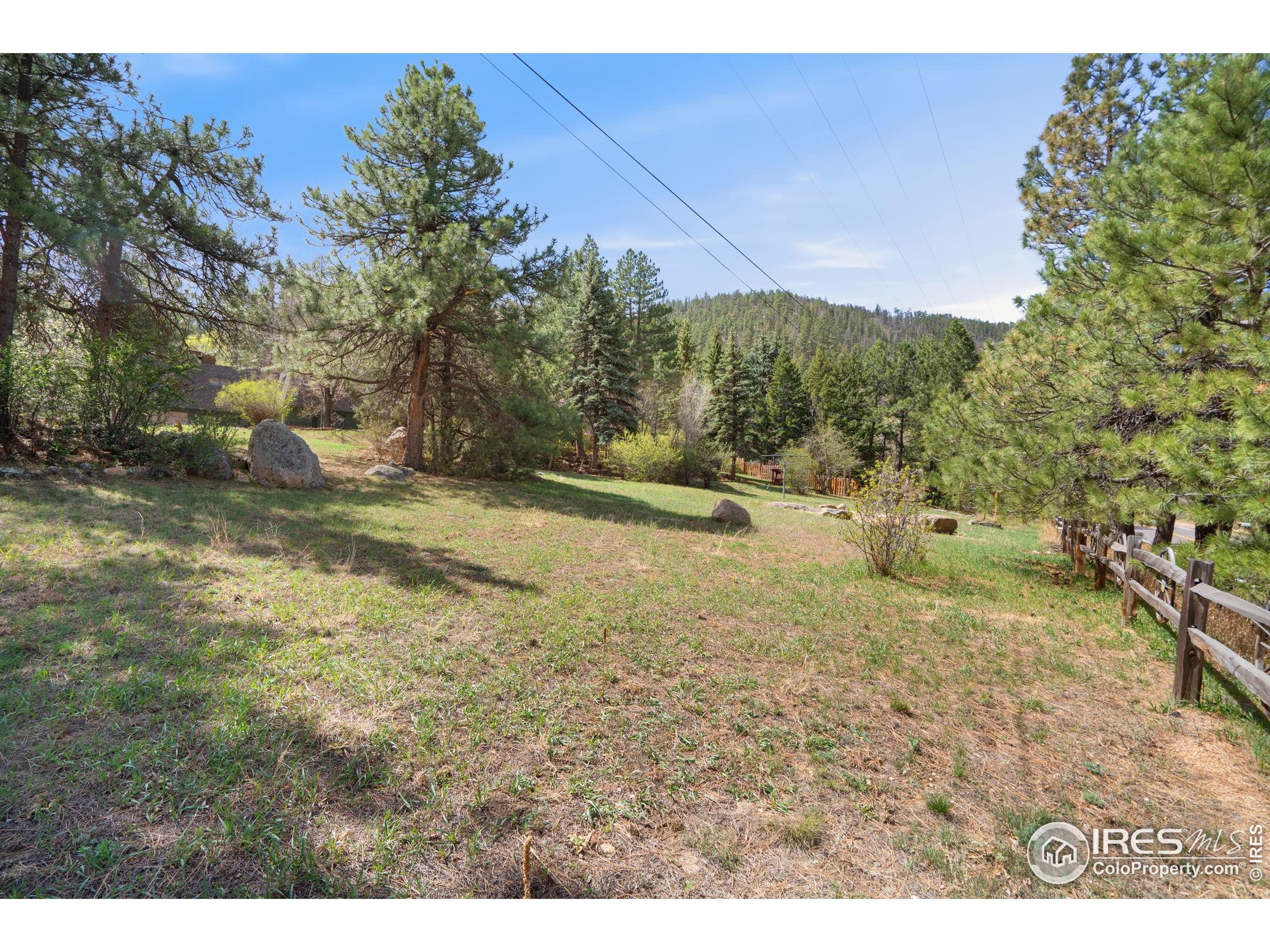 7301 Poudre Canyon Road Bellvue, CO 80512 - Photo 32 of 41 a view of a dry yard with trees