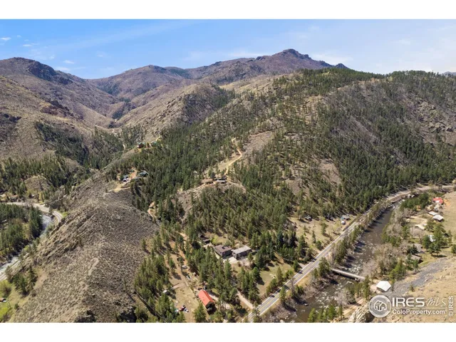 a view of a dry yard with mountains in the background