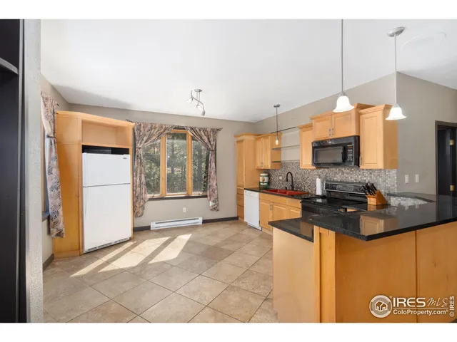 a kitchen with stainless steel appliances granite countertop a sink and a stove