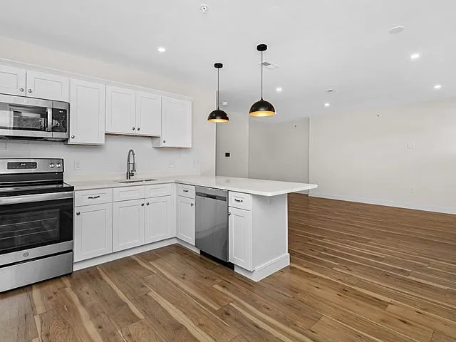 a kitchen with a sink stainless steel appliances and cabinets