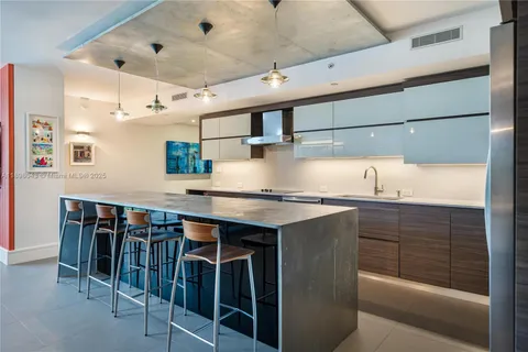 a kitchen with stainless steel appliances granite countertop a sink and cabinets