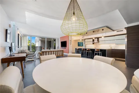 a large kitchen with a table and chairs