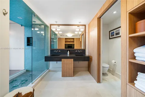 a spacious bathroom with a granite countertop sink and a mirror