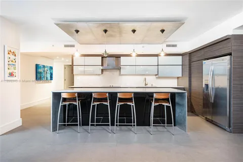 a kitchen with kitchen island a sink stainless steel appliances and cabinets