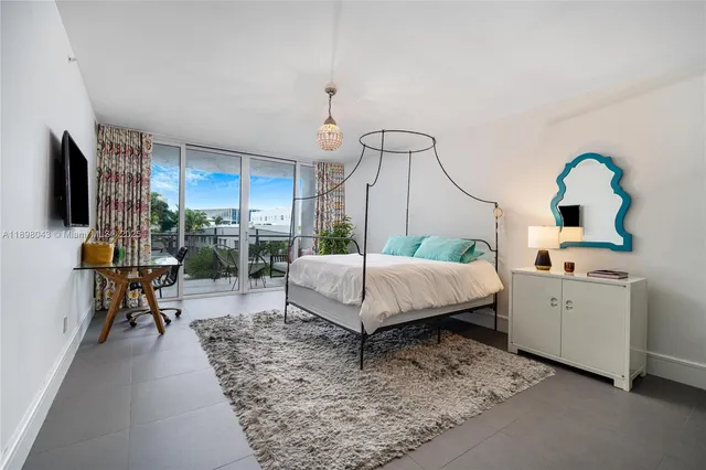 a living room with furniture a rug and white walls