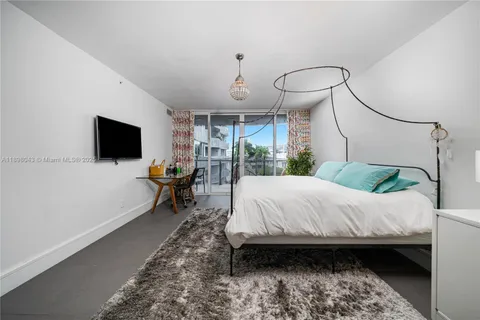 a bed room with a bed window and a chair