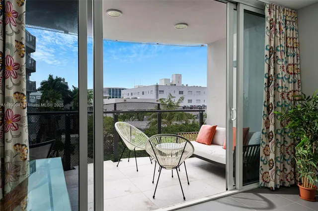 a balcony with chairs and a table