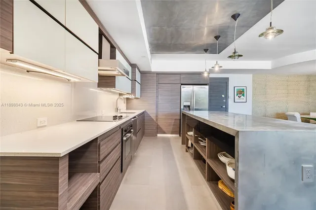 a kitchen with stainless steel appliances granite countertop a sink and a stove