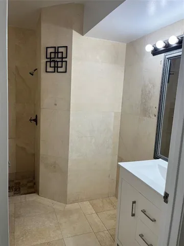 a bathroom with a shower and a sink