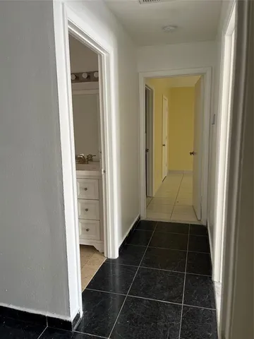 an entryway in a gallery with wooden floor