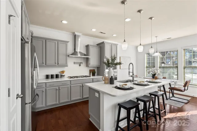 a kitchen with stainless steel appliances kitchen island granite countertop a sink and cabinets