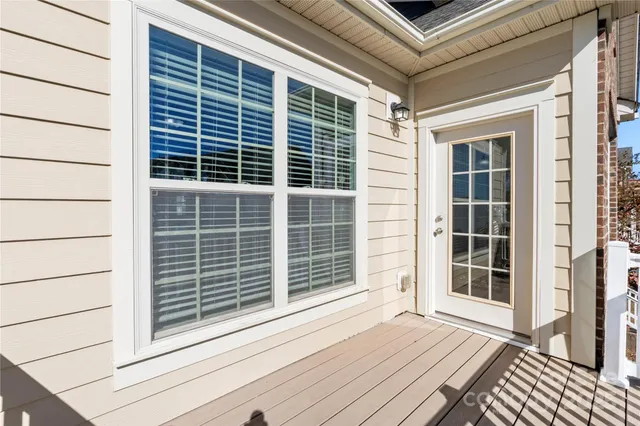 a view of a balcony with wooden floor and windows