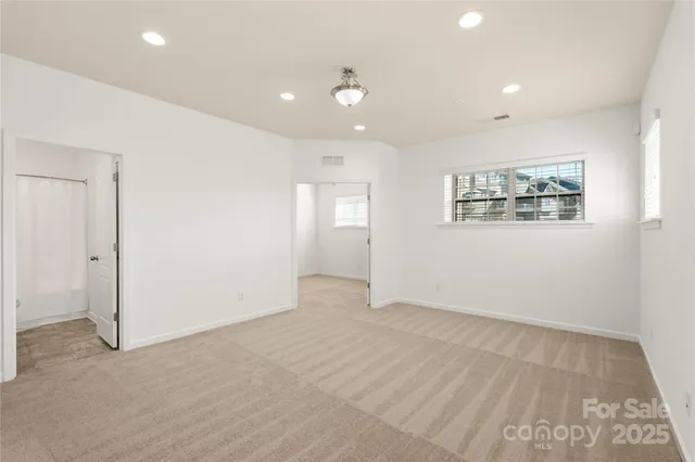 an empty room with windows and closet