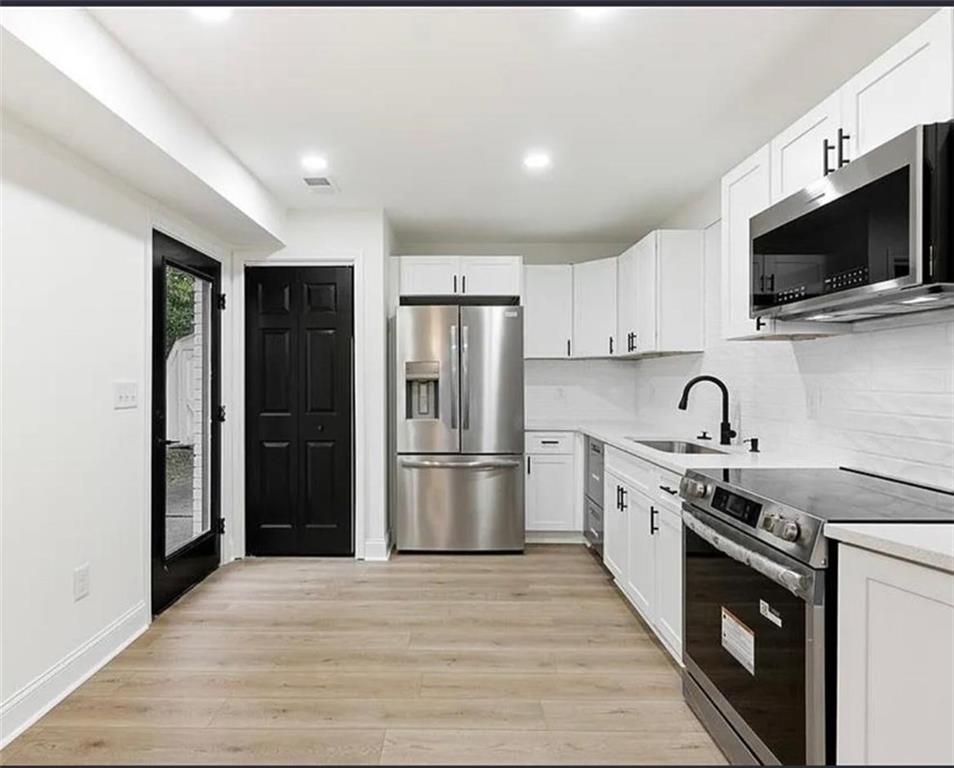 10 Hawk Road Northwest Cartersville, GA 30121 - Photo 3 of 23 a kitchen with stainless steel appliances granite countertop a stove top oven a refrigerator and a sink