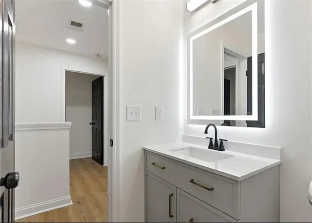 a bathroom with a sink and a mirror