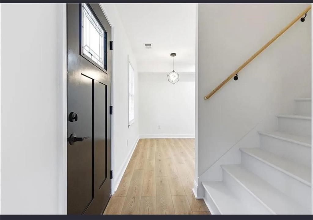 10 Hawk Road Northwest Cartersville, GA 30121 - Photo 6 of 23 a view of a hallway with wooden floor and staircase
