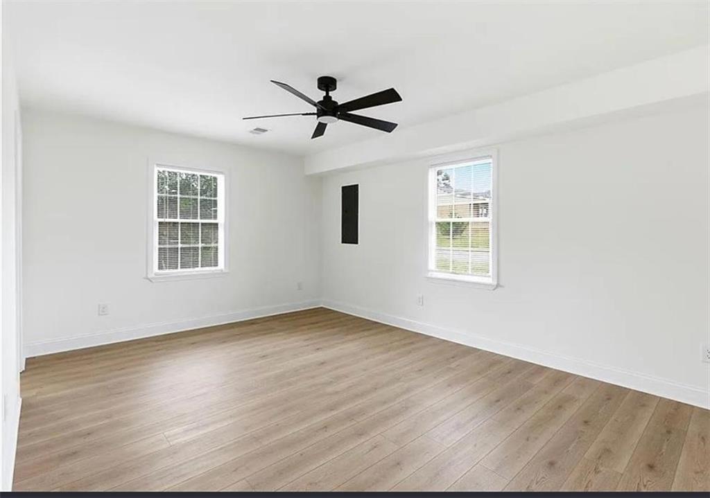 10 Hawk Road Northwest Cartersville, GA 30121 - Photo 7 of 23 a view of empty room with wooden floor and fan