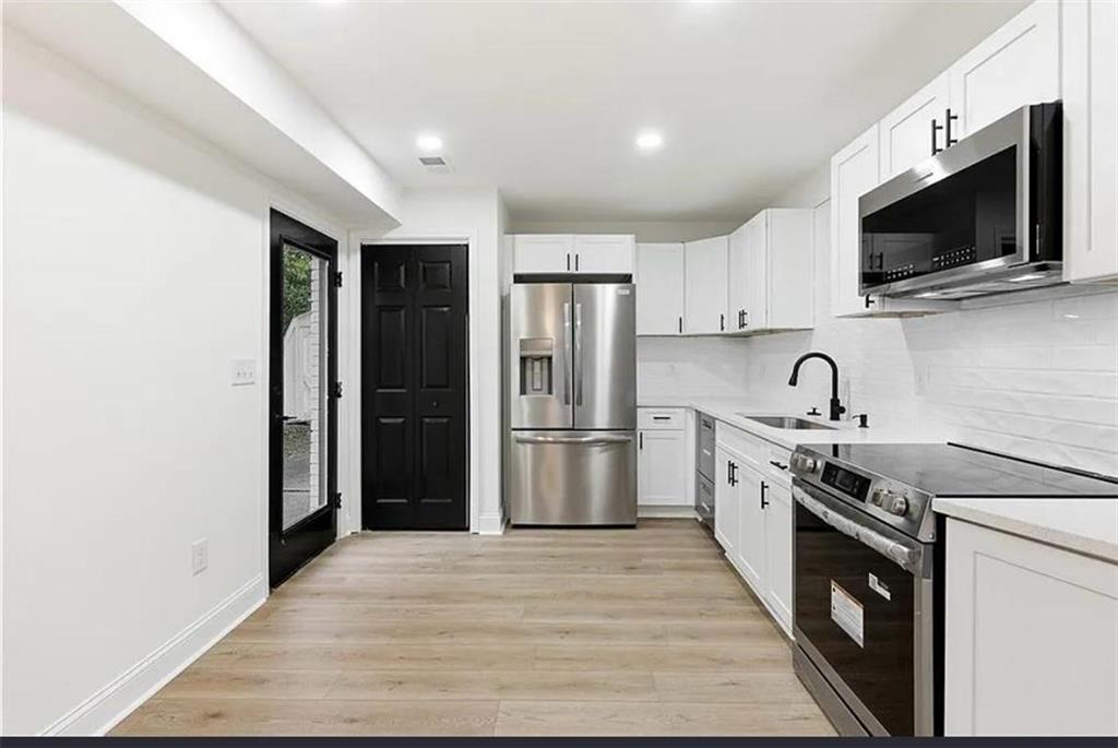 10 Hawk Road Northwest Cartersville, GA 30121 - Photo 9 of 23 a kitchen with stainless steel appliances granite countertop a refrigerator stove a sink dishwasher and microwave oven with cabinets
